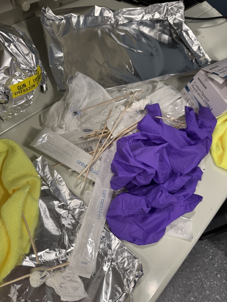 a large pile of discarded cotton swabs and gloves