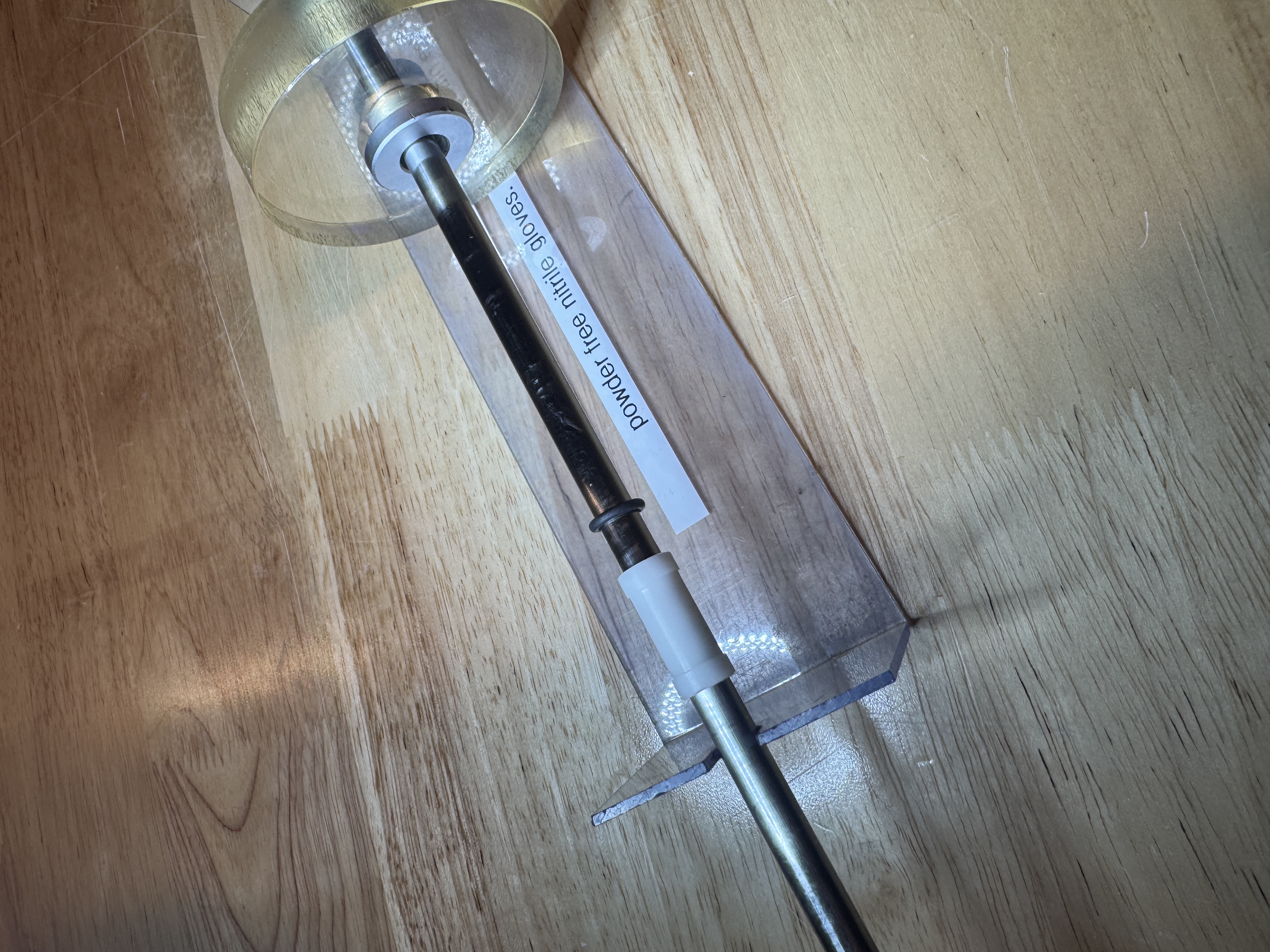 a disassembled specimen exchange rod, showing various components