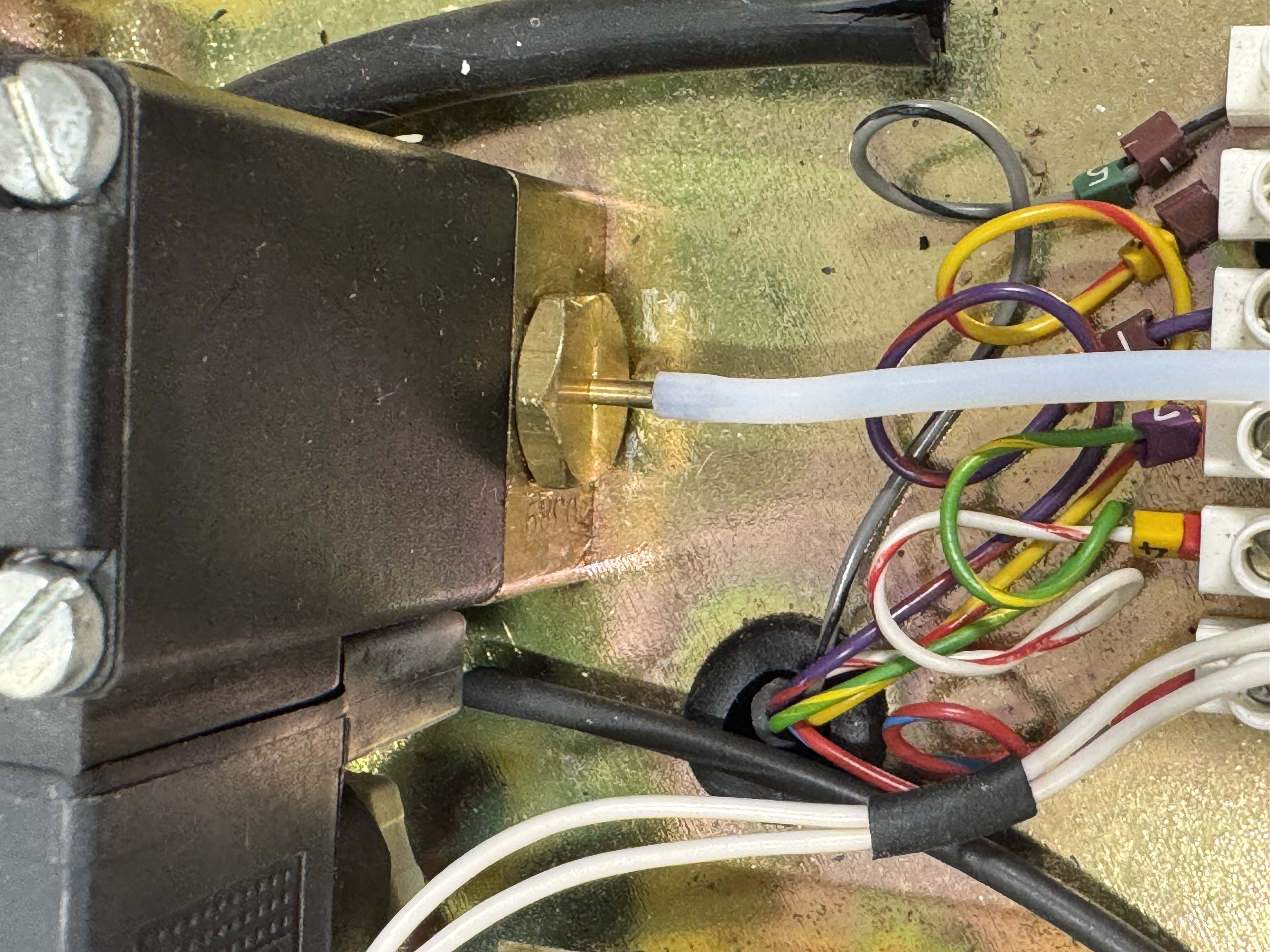 After heating our PTFE tube, in this image, you can see it has stretched enough to fit around the barb, and is now a snug fit.