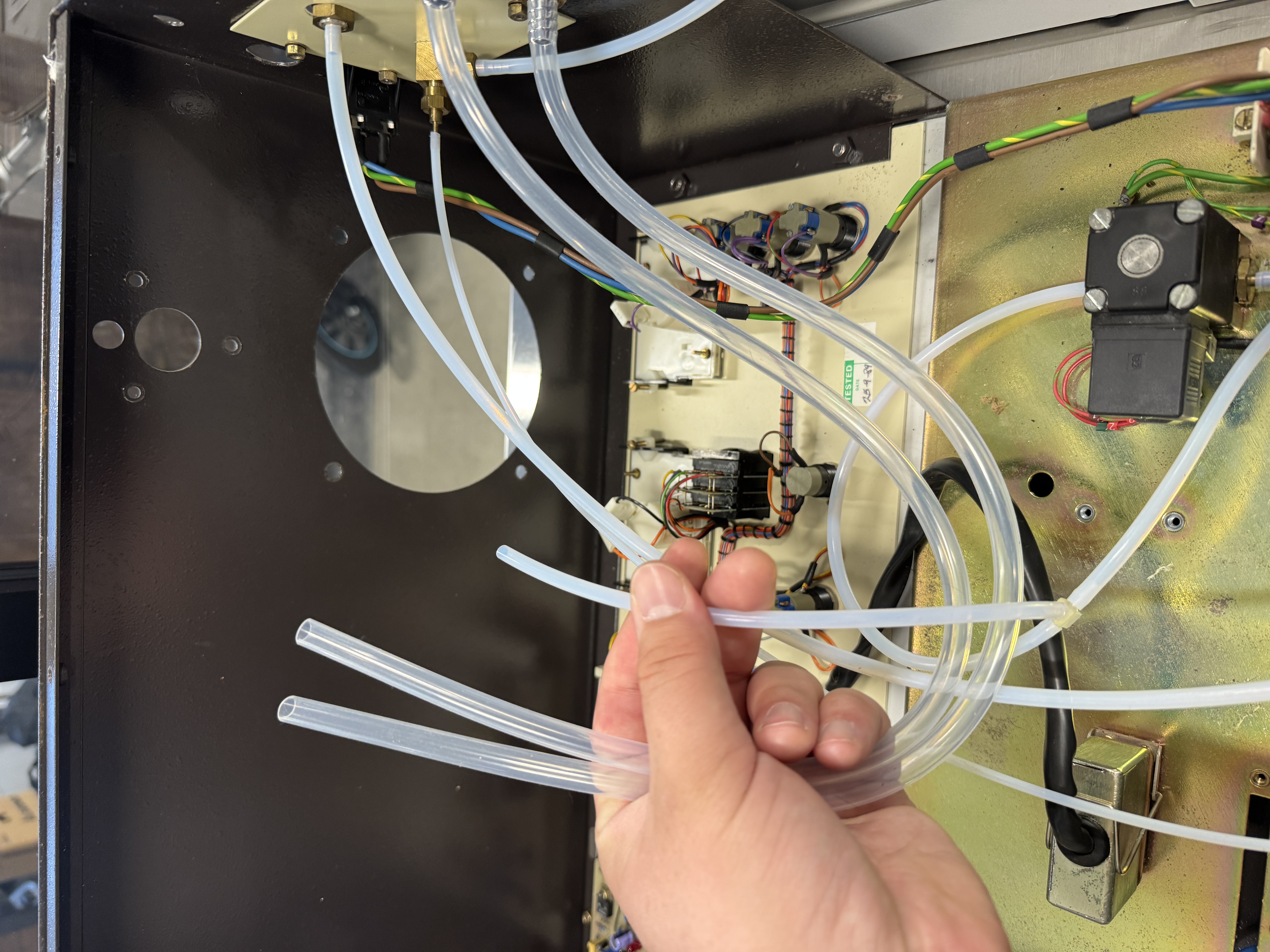 The tubing being held in place where it will eventually connect to the chamber
