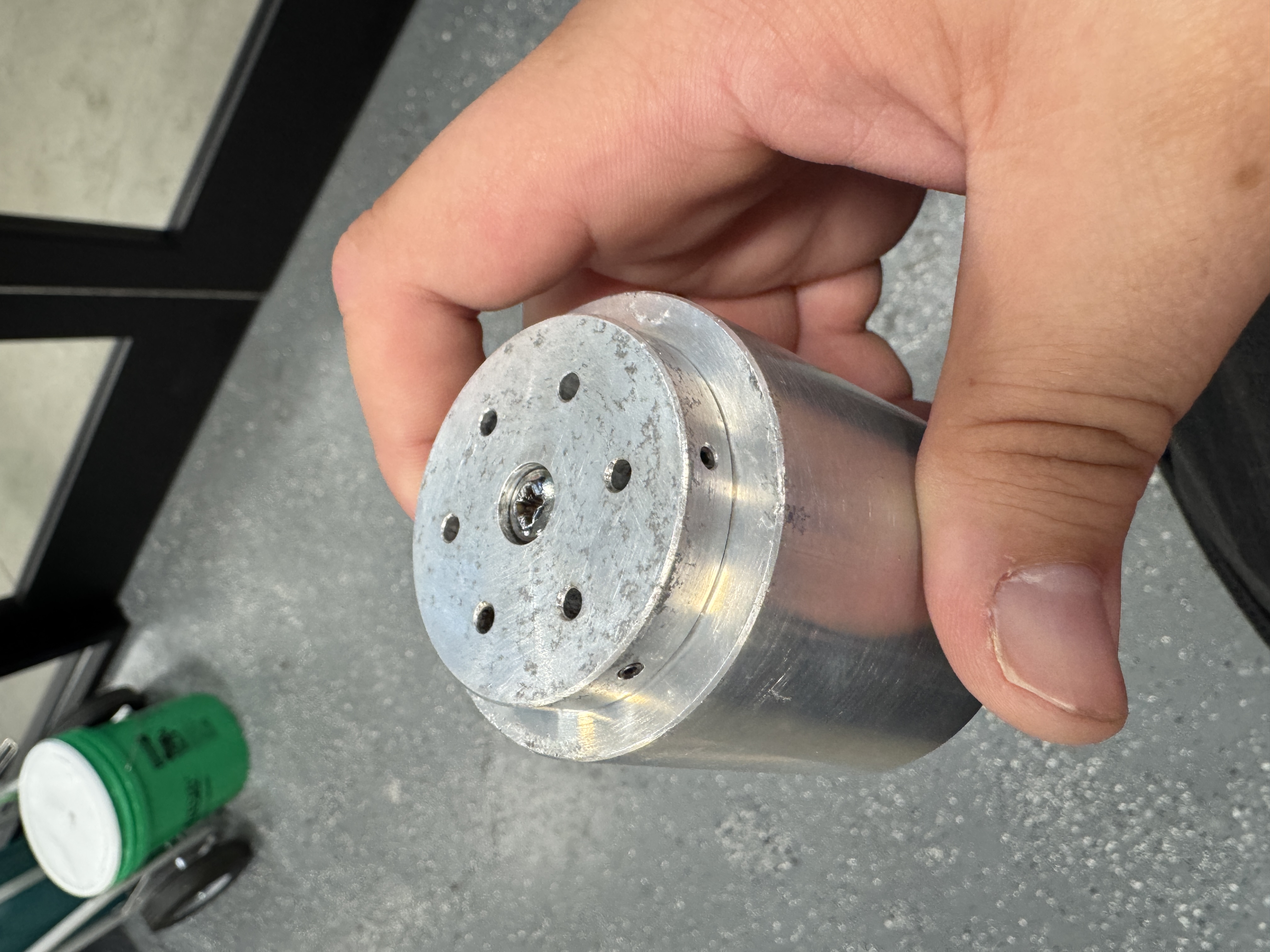 The result of the ultrasonic bath, showing a cleaner, but slightly scuffed specimen mount